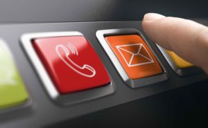 Man pressing an email button on a contact panel. Composite image between a finger photography and a 3D background.